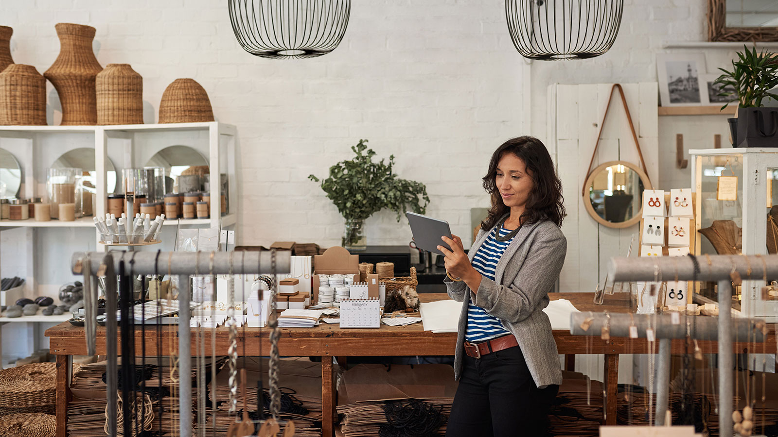 Young woman using a digital tablet in her boutique