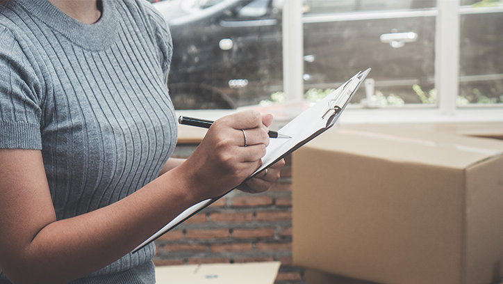 woman with clipboard taking inventory