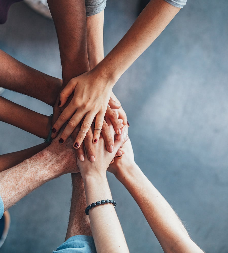 Stack of hands showing unity and teamwork