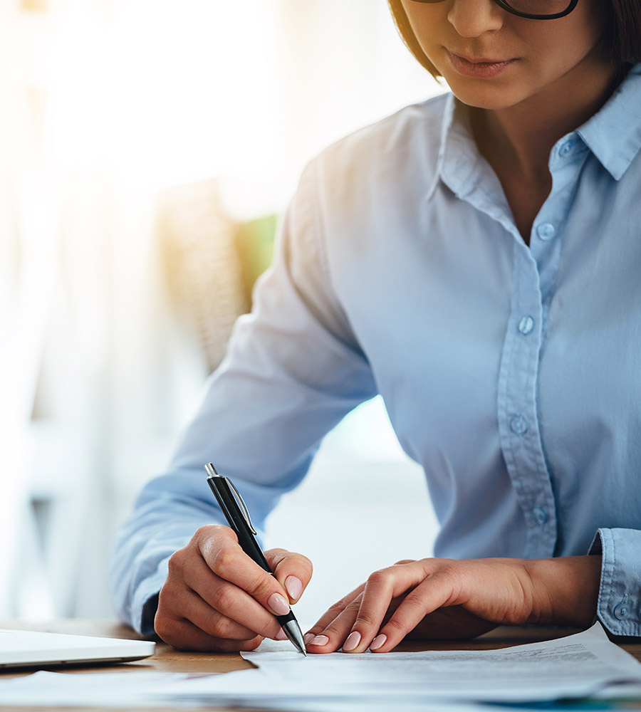 woman signing documents